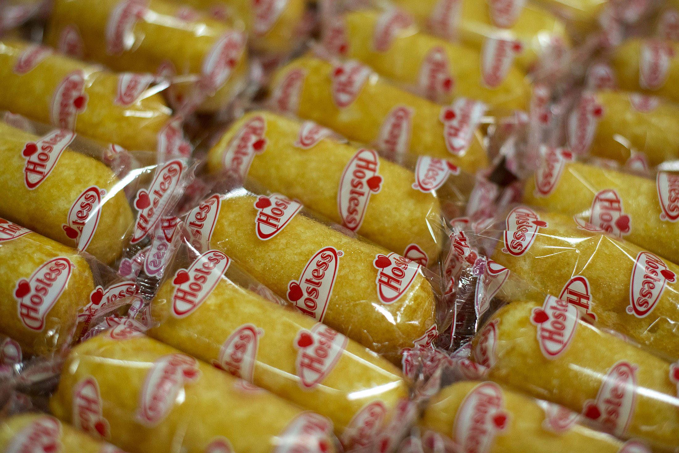 Hostess Brands LLC Twinkies snack cakes sit in a tray in the packaging area of a Hostess bakery in Schiller Park, Illinois, U.S., on Monday, July 15, 2013. Hostess Brands LLC officially revives sales of the iconic Twinkie snack cake today, following a seven-month hiatus after the original company decided to liquidate under bankruptcy.
