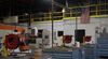 An American flag hangs above empty work stations at a manufacturing facility in Plymouth, Michigan.