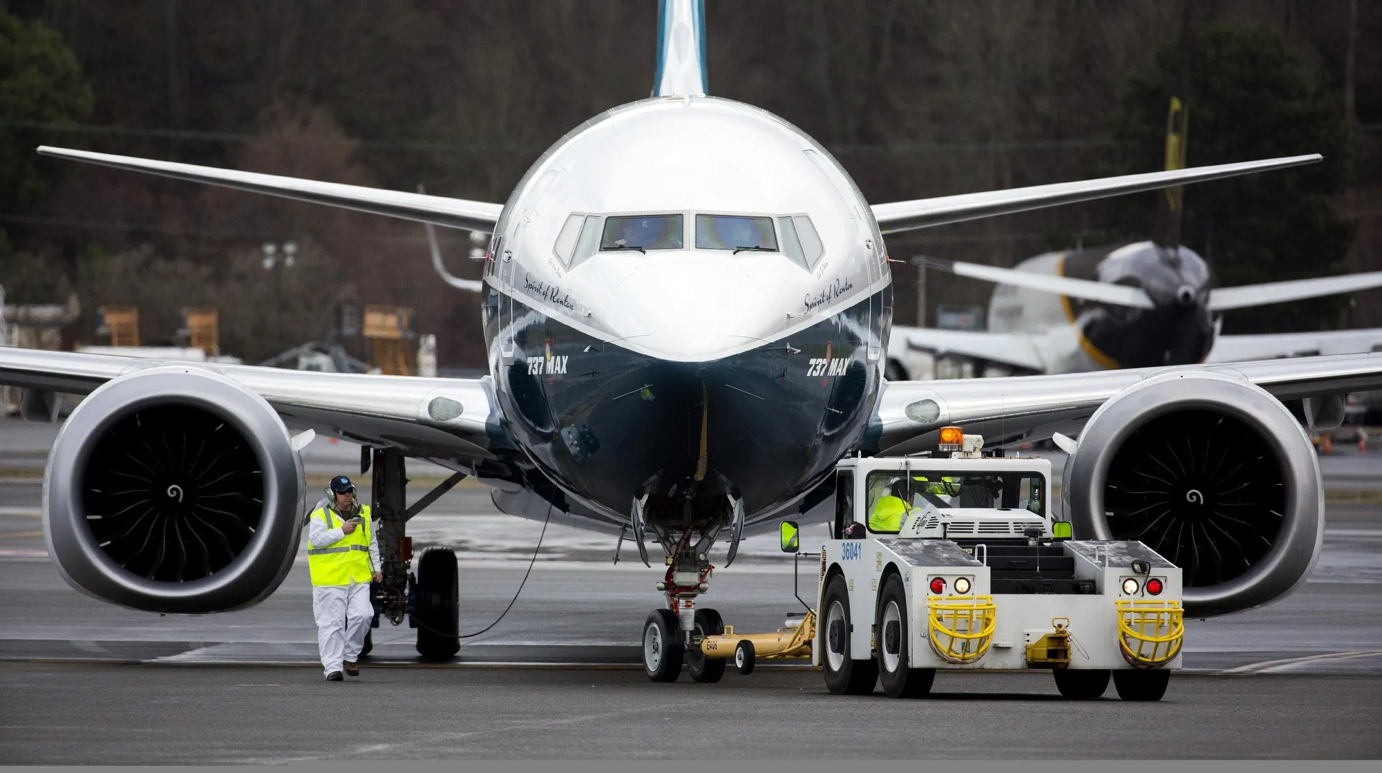 Crewman tow in a Boeing Co. Max 737 jet after landing at King County International Airport in Seattle, Washington, U.S., on Friday, Jan. 29, 2016. Boeing Co.'s newest 737 jetliner gunned its engines and headed into rain-streaked skies Friday, with profit and pride riding on its wings.
