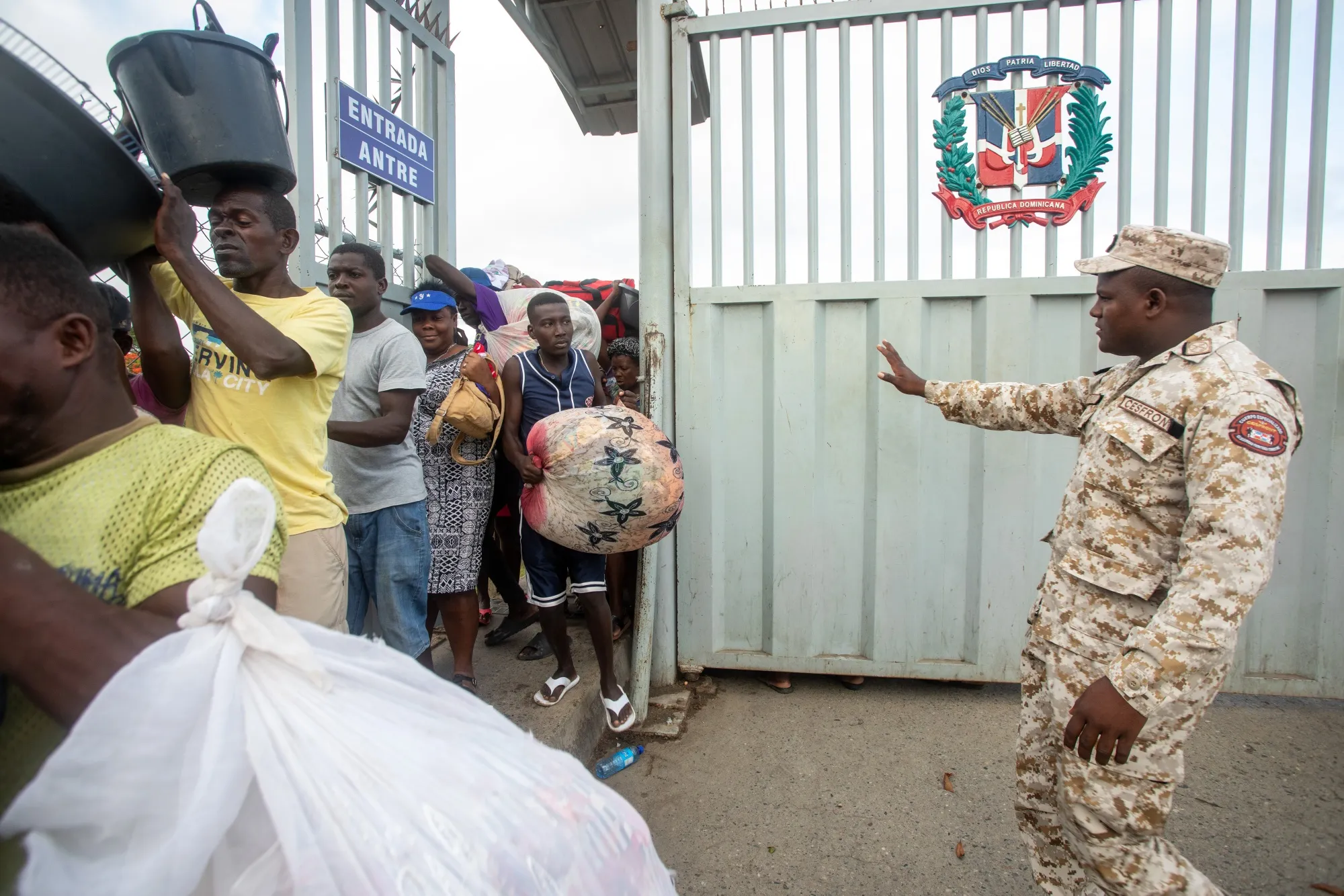 A border guard directs Haitians arriving on foot in Dajabon, Dominican Republic last year.