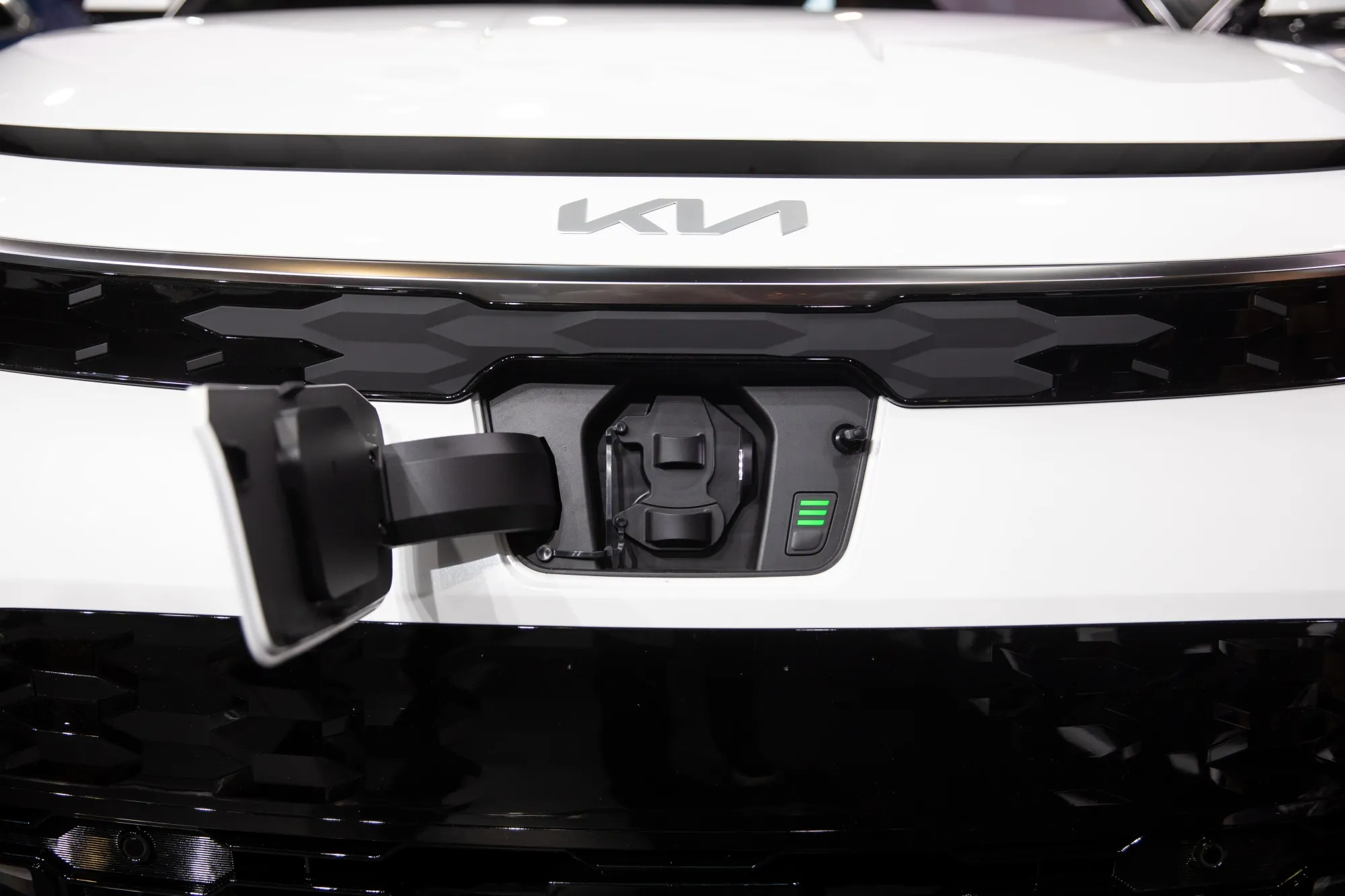 The charging port of a Kia Niro electric sports utility vehicle.