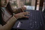 A young student attends an online coding class at her home in Mumbai.