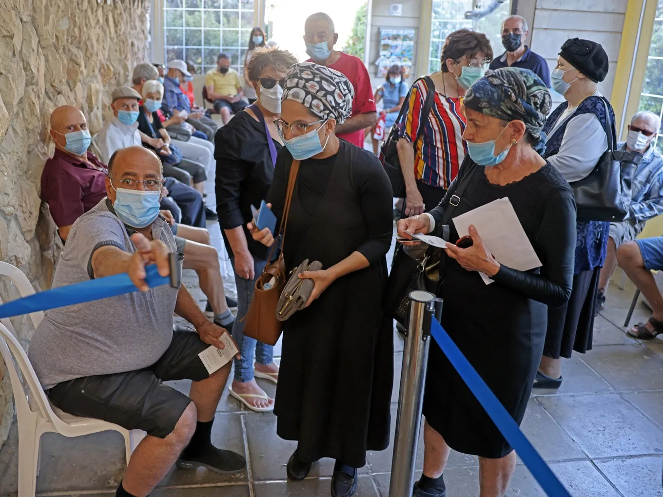 Israelis arrive to get their third dose of the Pfizer-BioNtech Covid-19 vaccine at the Clalit Health Service in Jerusalem.&nbsp;