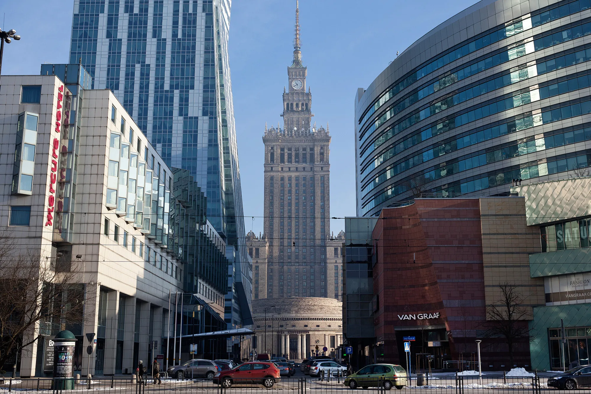 Road traffic passes commercial buildings and retail spaces, including the Palace of Culture and Science, center, in central Warsaw.