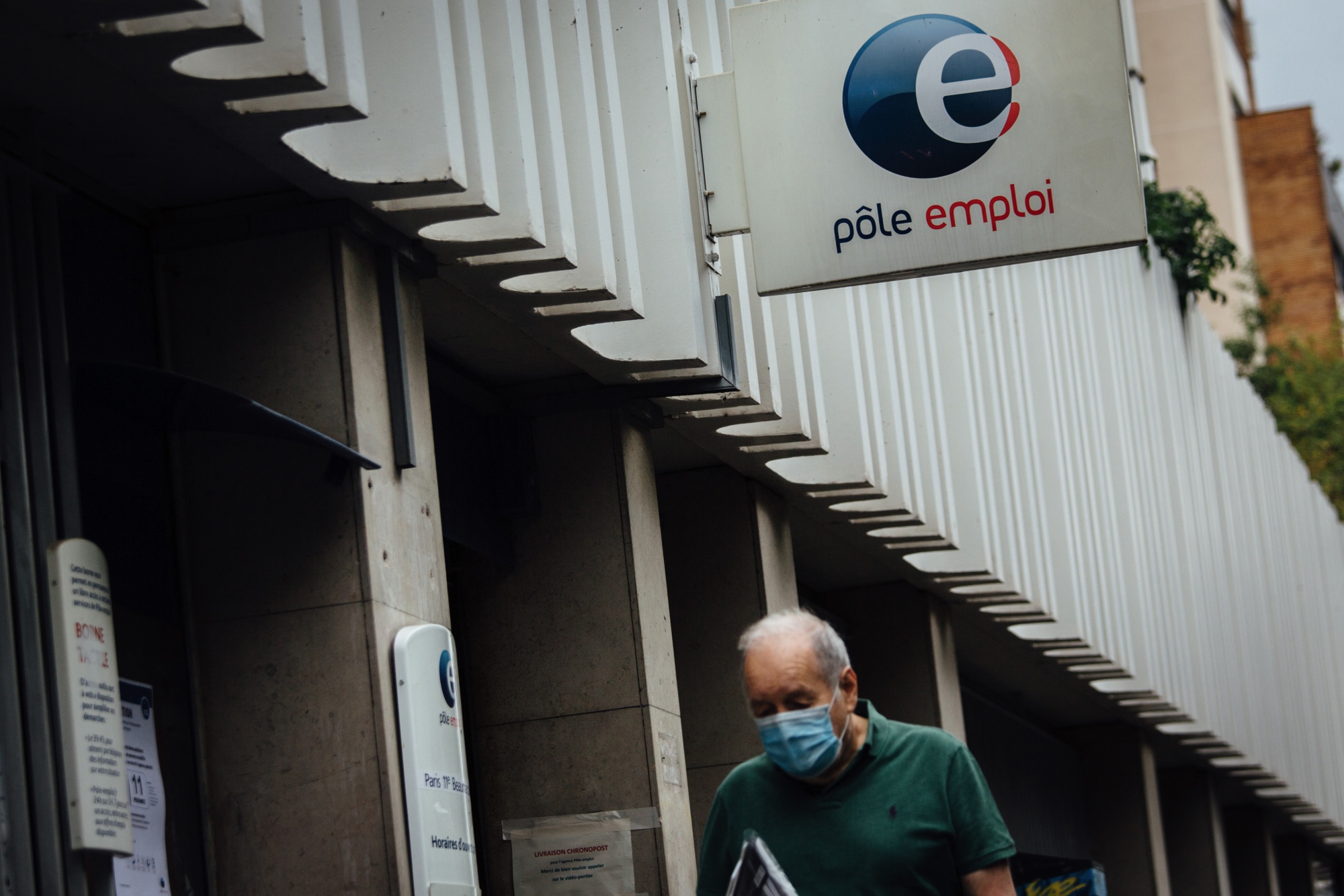A pedestrian&nbsp;passes a Pole Emploi job center in Paris.