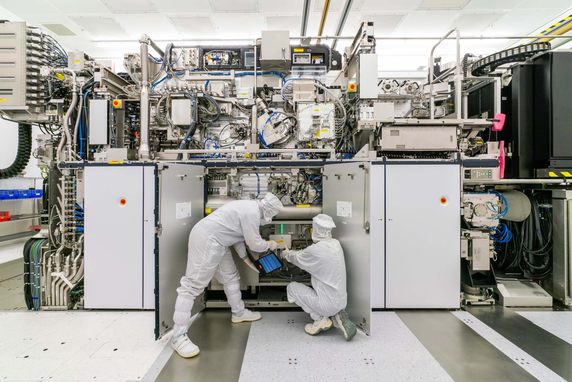 Employees assemble a lithography machine at the ASML Holding NV factory in Veldhoven, Netherlands. 