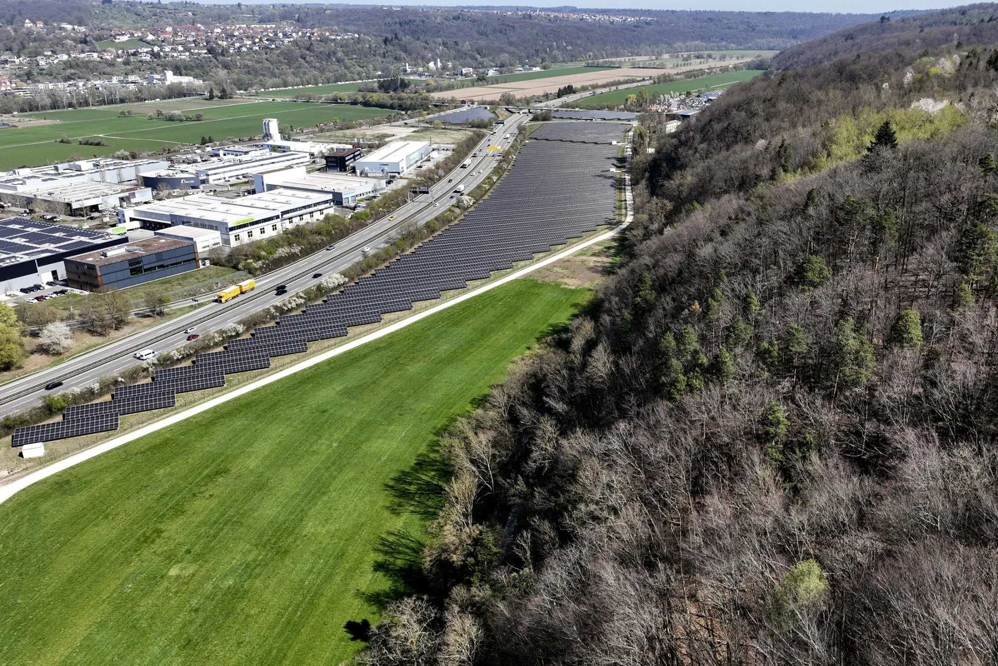 Undeveloped land remains on a proposed site for wind turbines that was canceled due to military restrictions, next to a solar park in Tübingen, Germany.
