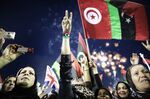 Libyans celebrate following the announcement of the liberation of the country in Martyr's Square,Tripoli, 2011.