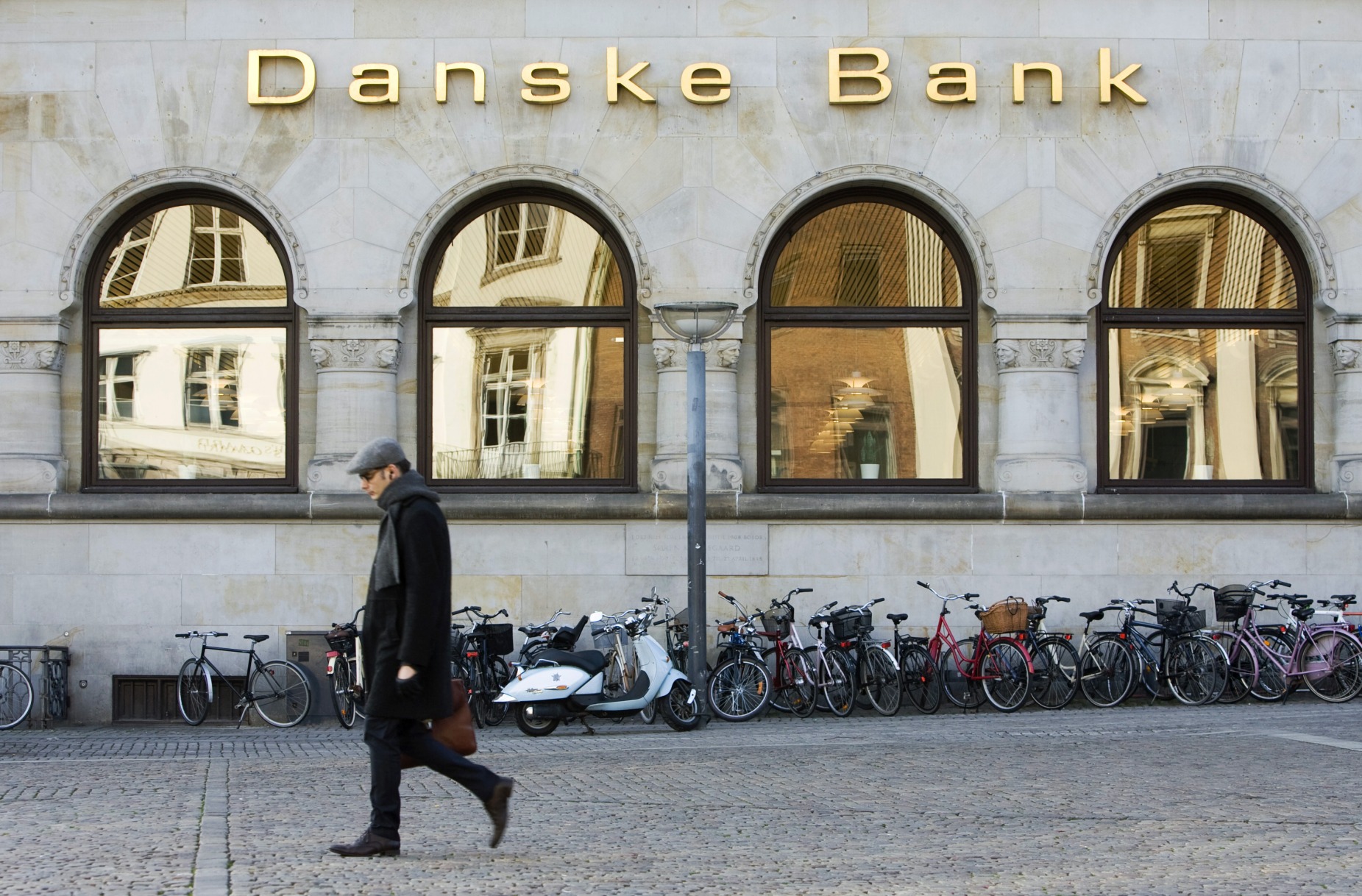 A pedestrian walks past a branch of Danske Bank A/S in Copenhagen.
