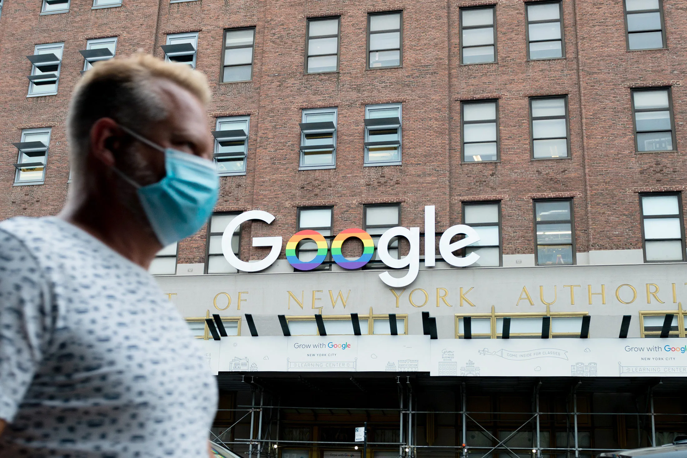 &nbsp;A man wearing a mask walks past the Google officers&nbsp;in New York.