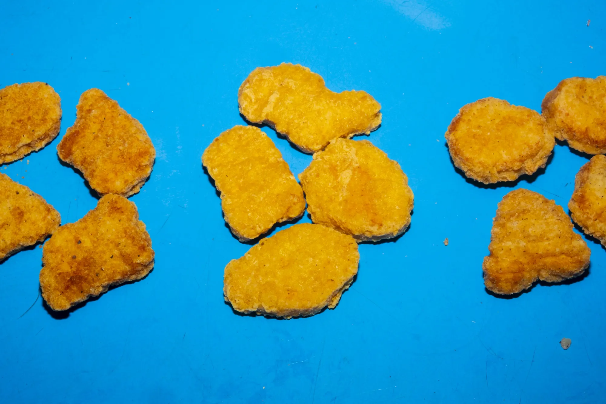 Four-piece chicken nuggets from Burger King, McDonald's, and Wendy's, part of value meal menus, arranged in New York, US.