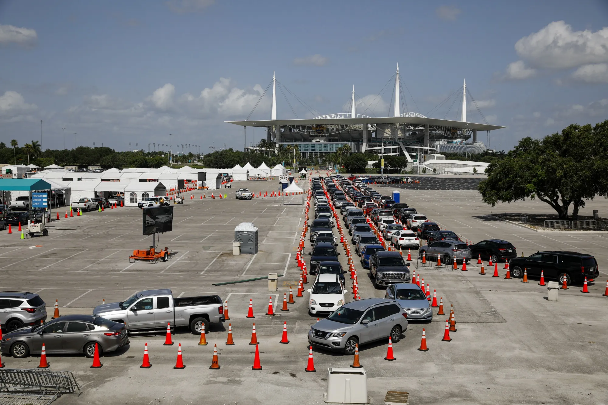 People sit in their vehicles while waiting in line to enter a Covid-19 drive-thru testing site at Hard Rock Stadium in Miami Gardens, Florida,&nbsp;on&nbsp;June 30.