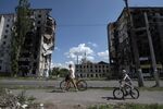 Residents pass destroyed buildings in Borodianka, Ukraine.