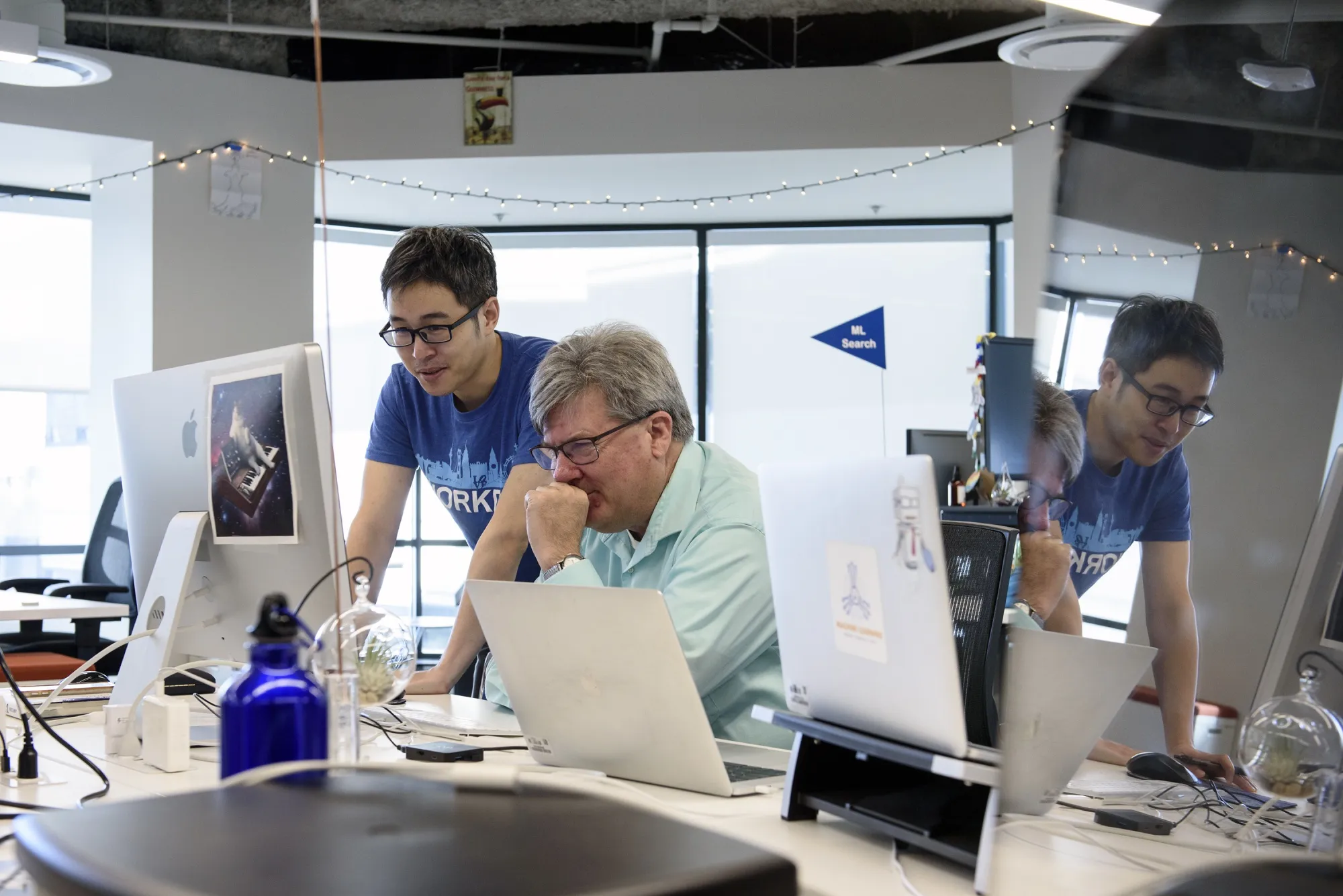 Employees work together at their desks at Workday's offices in San Francisco.