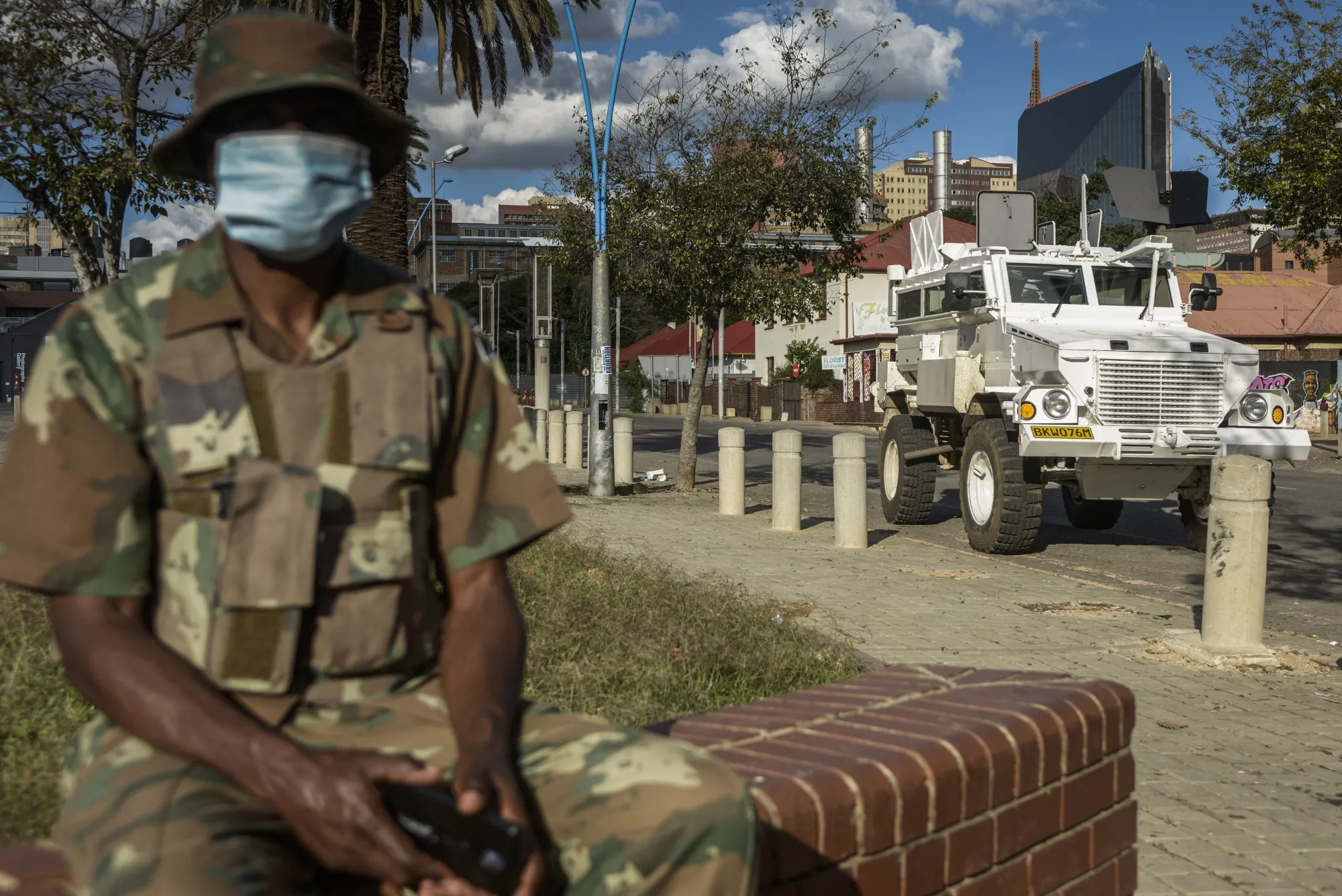 A soldier from the South African National Defence Force sits alongside an armored vehicle in Johannesburg, South Africa on&nbsp;April 6.