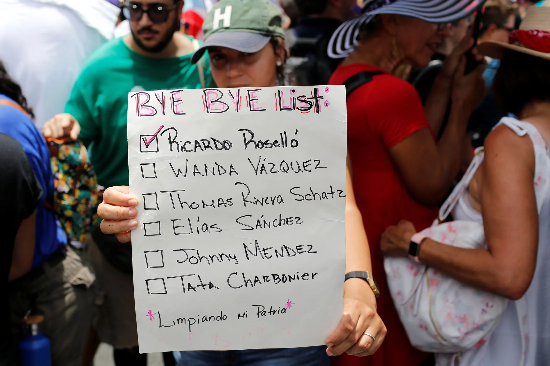 A woman holds a sign during a rally to celebrate the resignation of Puerto Rican Governor Ricardo Rosselló in San Juan on July 25.&nbsp;