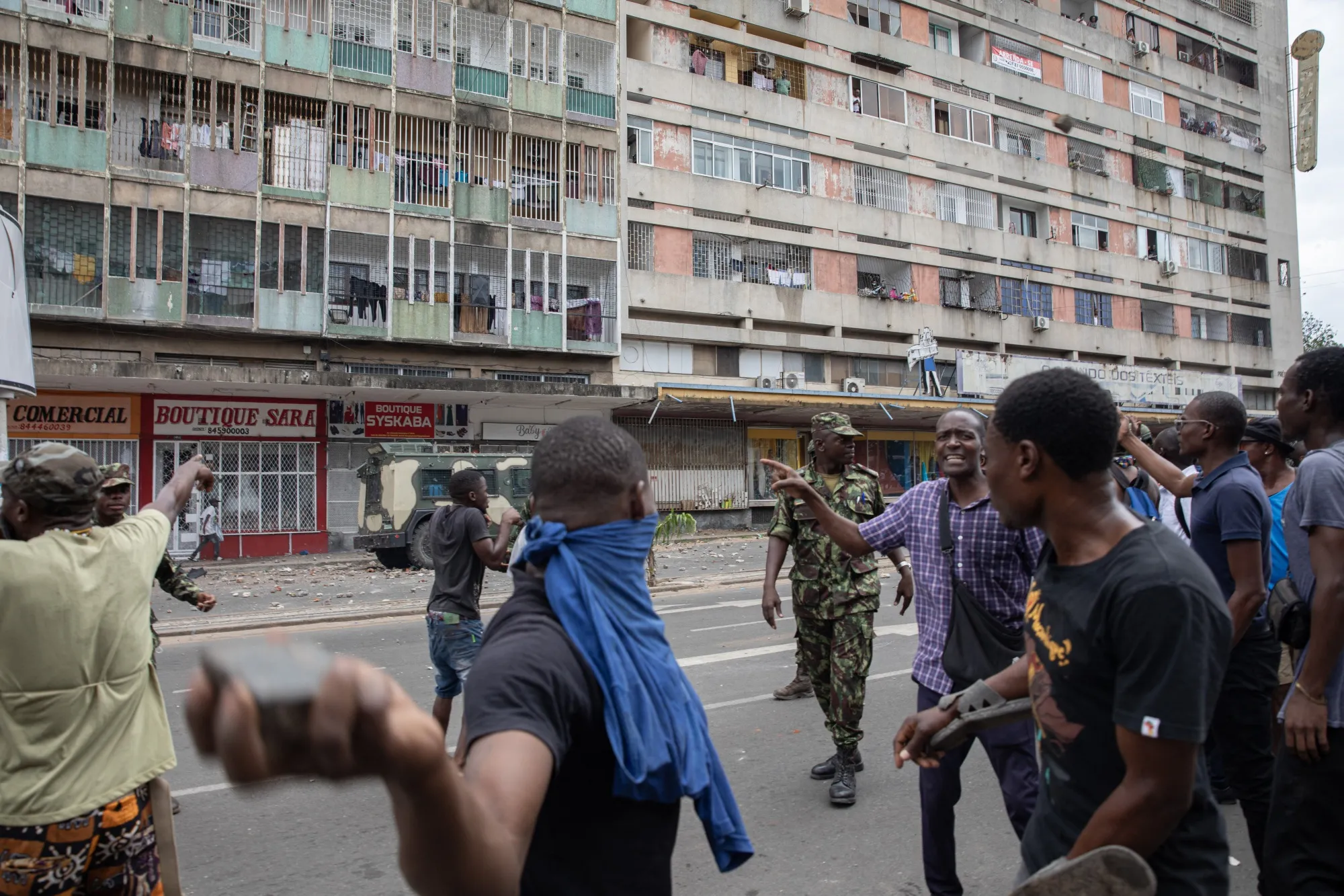 A soldier attempts to disperse protesters in Maputo on Nov. 27.