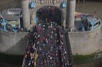Competitors run over Tower Bridge as they compete in the 2022 London Marathon. 