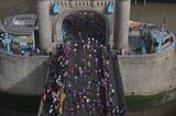 Competitors run over Tower Bridge as they compete in the 2022 London Marathon. 