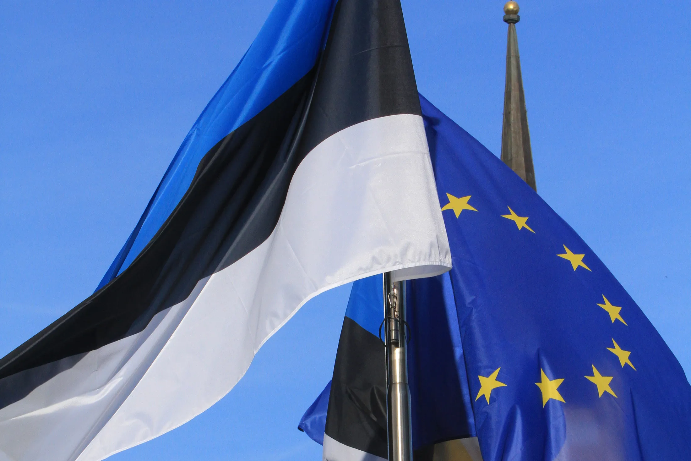 The Estonian and the European flag are pictured during the opening concert at the Freedom Square in Tallinn to celebrate Estonia's six month EU Presidency on June 29, 2017. European Commission President Jean-Claude Juncker heads a visit of the 28-member EU body kicking off Estonia's six month stint as rotating president of the bloc facing Brexit. / AFP PHOTO / Petras Malukas (Photo credit should read PETRAS MALUKAS/AFP/Getty Images)
