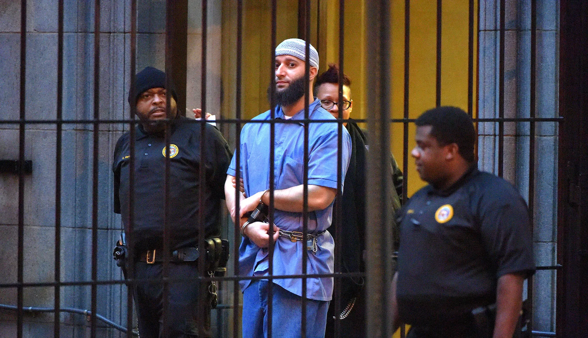 Officials escort Adnan Syed from the courthouse on February 3, 2016, following the completion of the first day of hearings for a retrial in Baltimore.