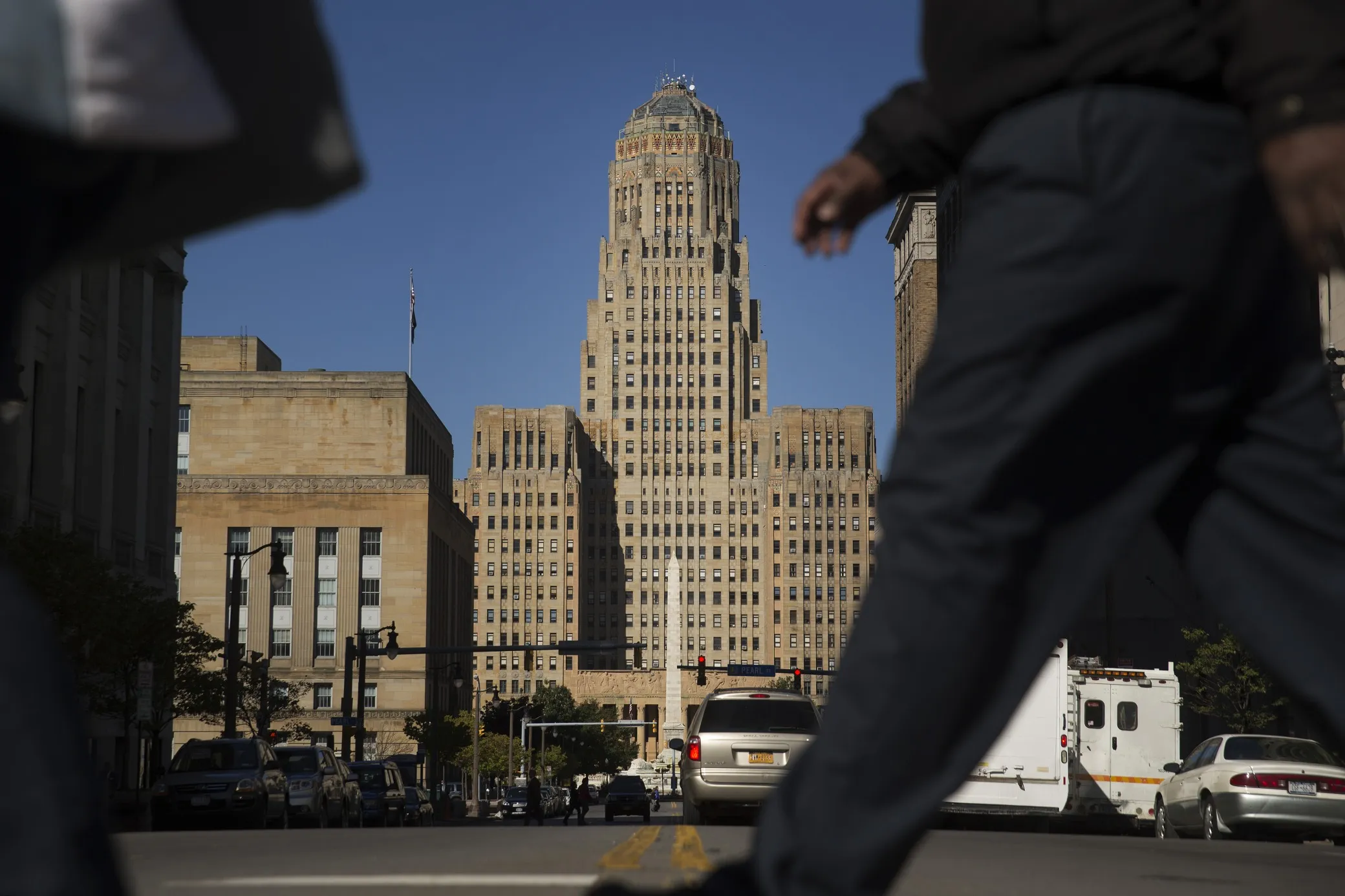 Pedestrians walk past Buffalo City Hall in Buffalo, New York.