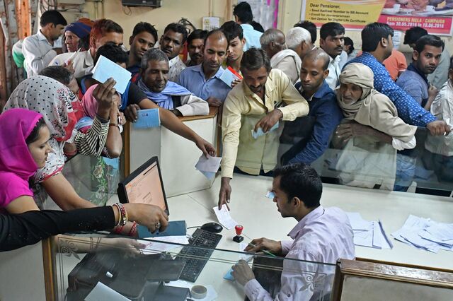 Customers wait to exchange Indian five hundred and one thousand rupee banknotes at a Syndicate Bank branch in Dadri, India in Nov. 2016, after Prime Minister Narendra Modi shocked the nation with the withdrawal of large denomination notes, making up 86% of currency in circulation.