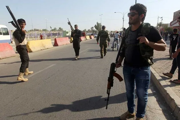 Iraqi tribesmen carry their weapons as they gather to show their readiness to join Iraqi security forces in the fight against Jihadist militants who have taken over several northern Iraqi cities on June 16 in Baghdad