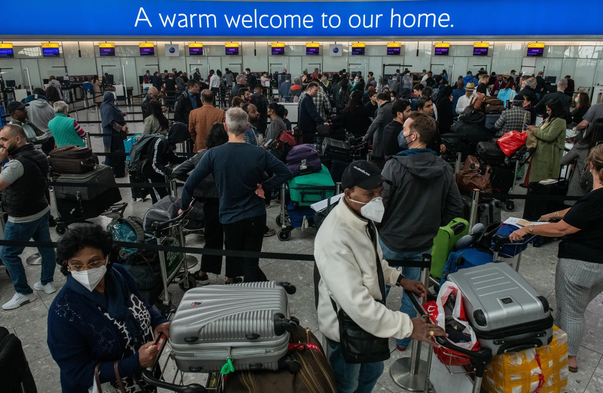 Passengers queue to check in at British Airways desks at London Heathrow Airport in London, UK.