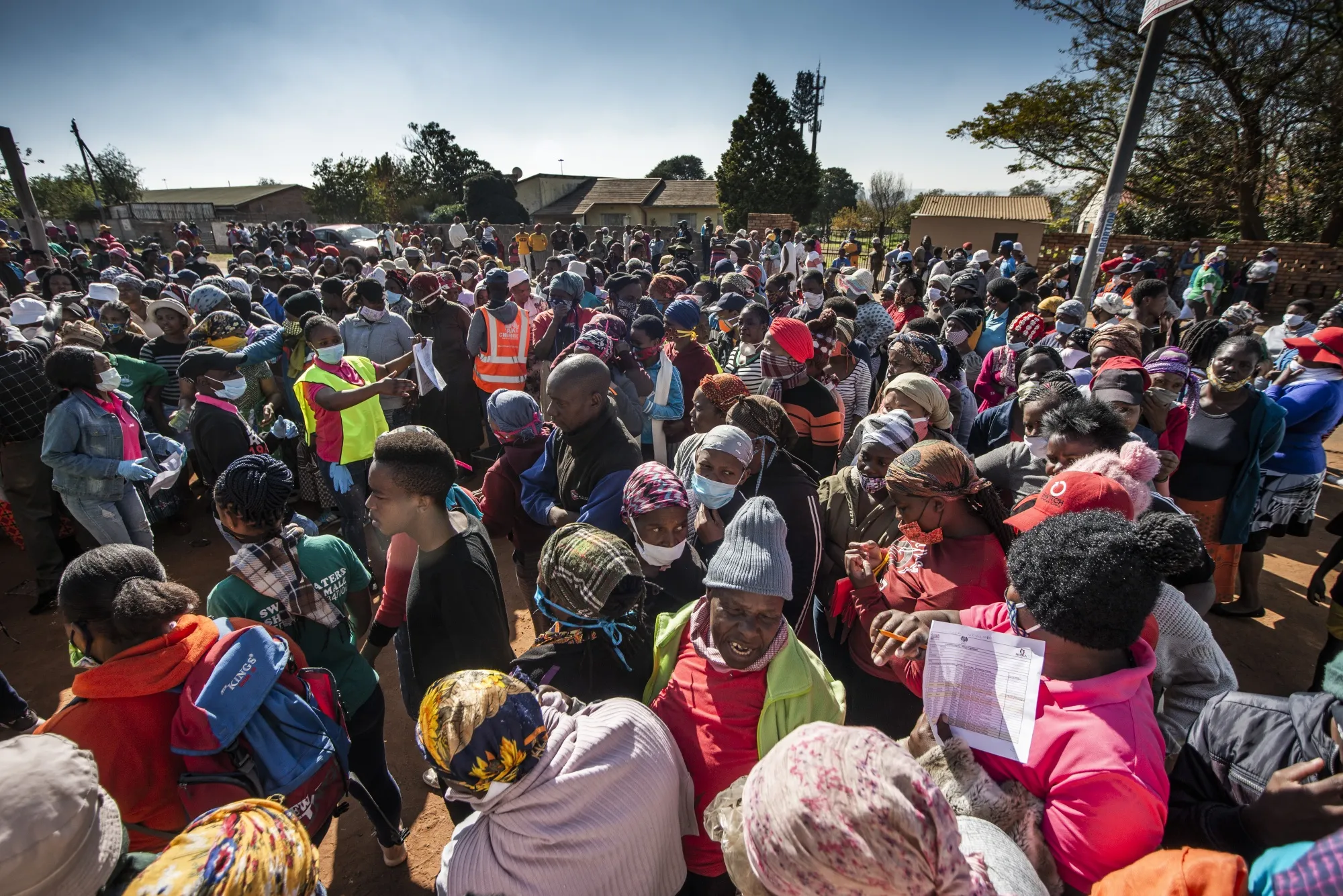 Crowds receive food parcels at the Zenzele Counselling Project in Finetown, May 7.