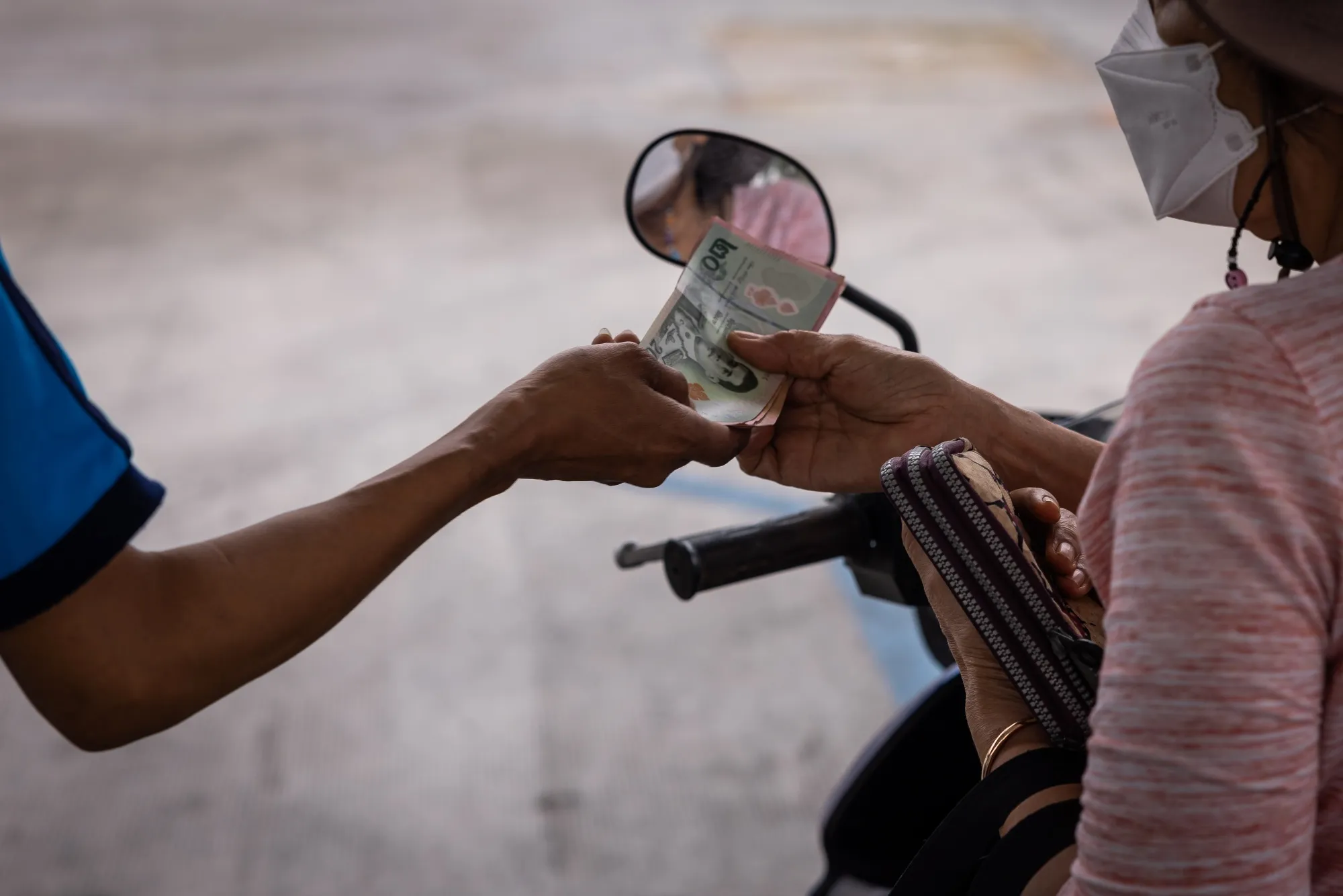 A customer pays for fuel at a PTT Pcl gas station in Bangkok.