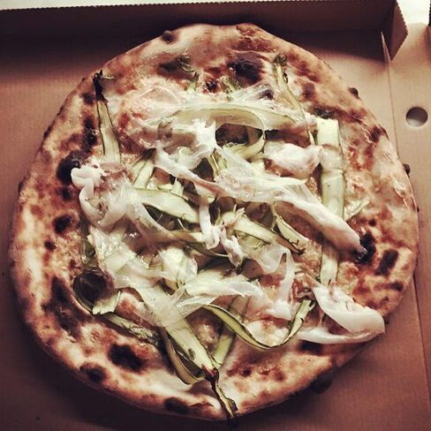 Omnipollos hatt's pizza of the month, featuring aged parmesan, lardo, lemon, and asparagus from Gotland.