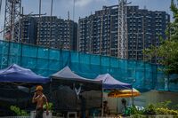 Construction workers near the Emerald Bay residential project developed by China Evergrande. 