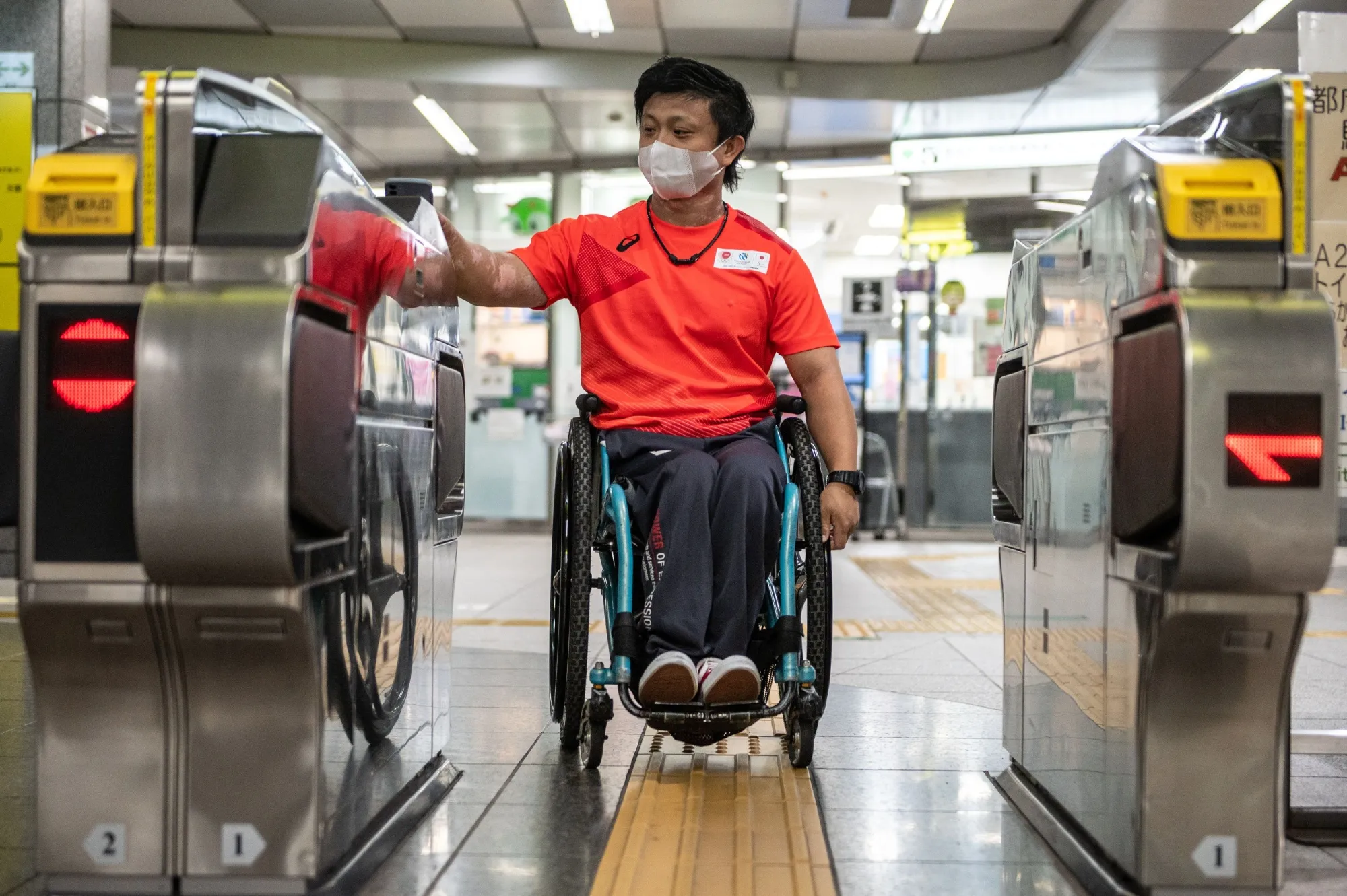 Japanese athlete&nbsp;Masaaki Suwa demonstrates&nbsp;the&nbsp;new barrier-free&nbsp;fare system inside the Tokyo Metro&nbsp;in August 2021. Japan's efforts to improve accessibility and inclusion were spurred by Tokyo’s selection&nbsp;to host the 2020/1 Olympics and Paralympics.&nbsp;