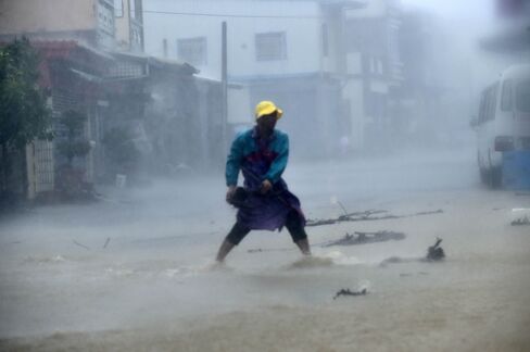 A local resident removes a rock from a blocked road.