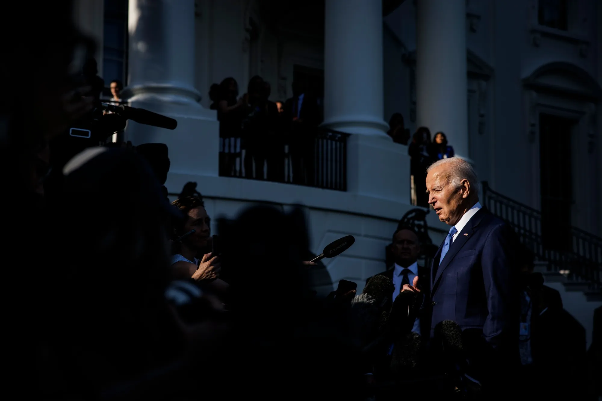 Joe Biden talks to reporters as he departs the White House&nbsp;on Friday.