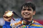Gold medalist Neeraj Chopra, of India, poses during the medal ceremony for the men's javelin throw at the 2020 Summer Olympics, Saturday, Aug. 7, 2021, in Tokyo. In India, there's a wave of kids picking up the javelin. They all want to be the next Neeraj Chopra, who became the country's first Olympic champion in track and field during the Tokyo Games. (AP Photo/Martin Meissner, File)