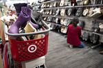 An employee adjusts a display of winter boots at a Target store in Chicago.
