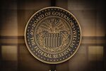 The seal of the U.S. Federal Reserve Board of Governors across the street from the Marriner S. Eccles Federal Reserve building in Washington, D.C., U.S., on Sunday, Dec. 19, 2021.