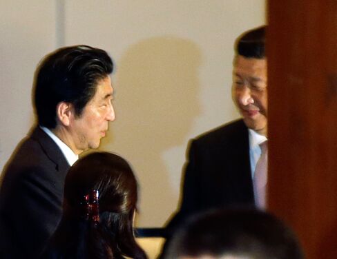 Japan's Prime Minister Shinzo Abe, left, talks with Chinese President Xi Jinping during their bilateral meeting on the sideline of the Asian African Summit in Jakarta, Indonesia on April 22, 2015.