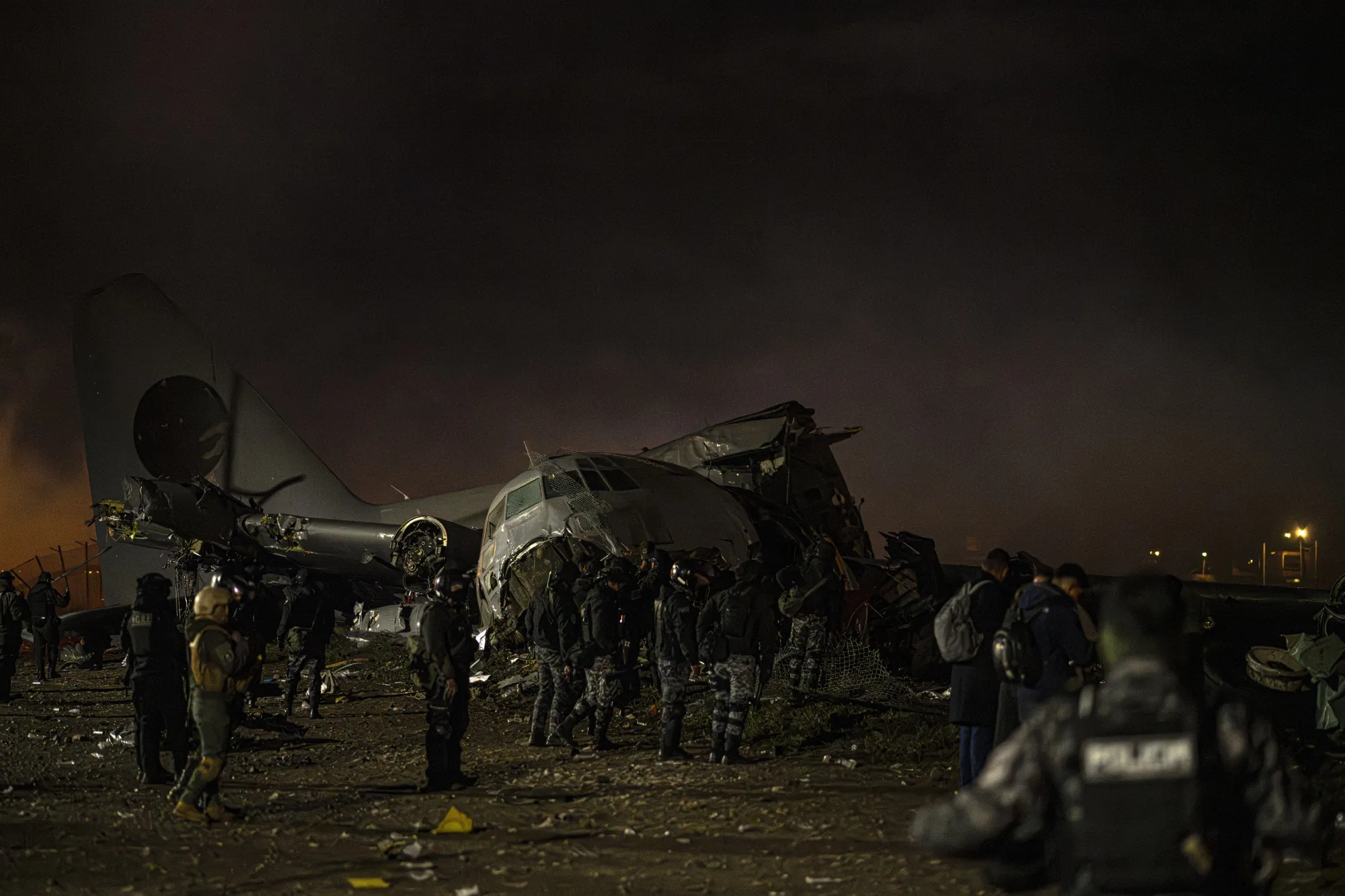Police and military at the scene of a plane crash in El Alto, Bolivia, on Feb. 27.