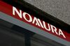 The Nomura Holdings Inc. logo is displayed outside a Nomura Securities Co. branch in Tokyo, Japan.