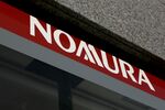The Nomura Holdings Inc. logo is displayed outside a Nomura Securities Co. branch in Tokyo, Japan.