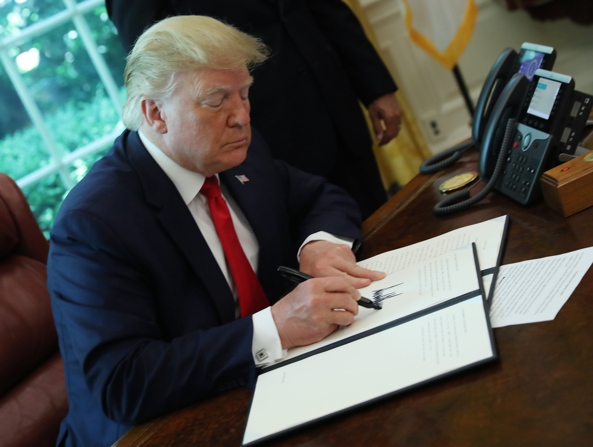 Signing an executive order imposing new sanctions on Iran, June 2019.