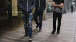 A group of men walks through a public space at Twitter Inc. headquarters.
