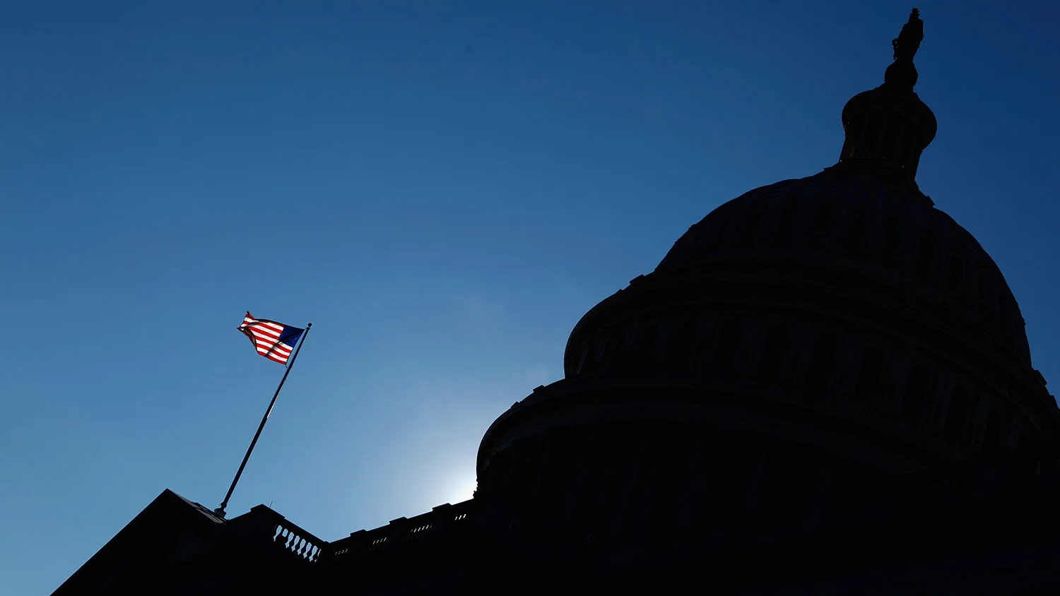 The flag waves in front of the U.S. Capitol on Dec. 19, 2011, in Washington.
