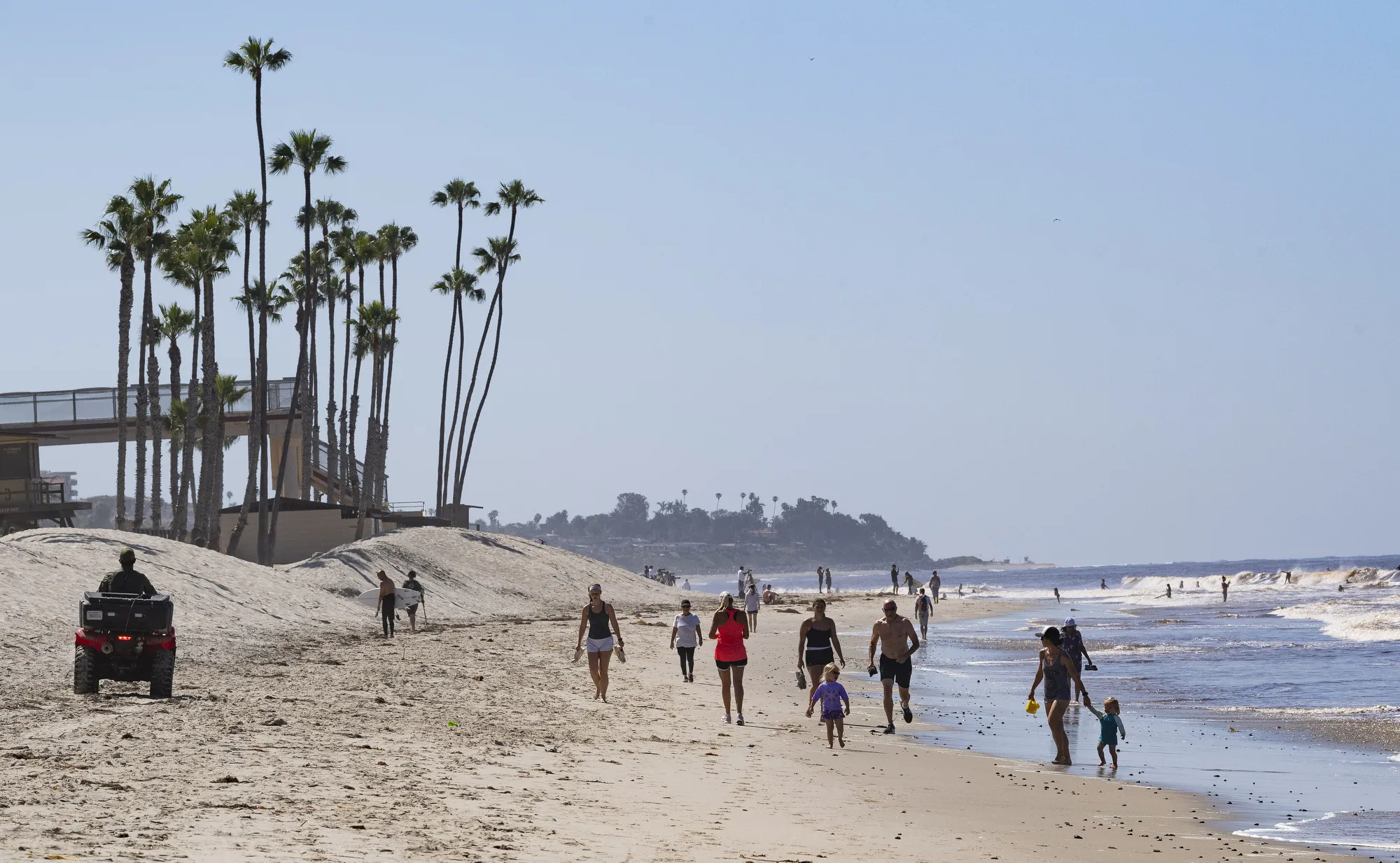 Visitors walk on the beach in San Clemente, an affluent town that could be the home of a new Amazon distribution hub.&nbsp;