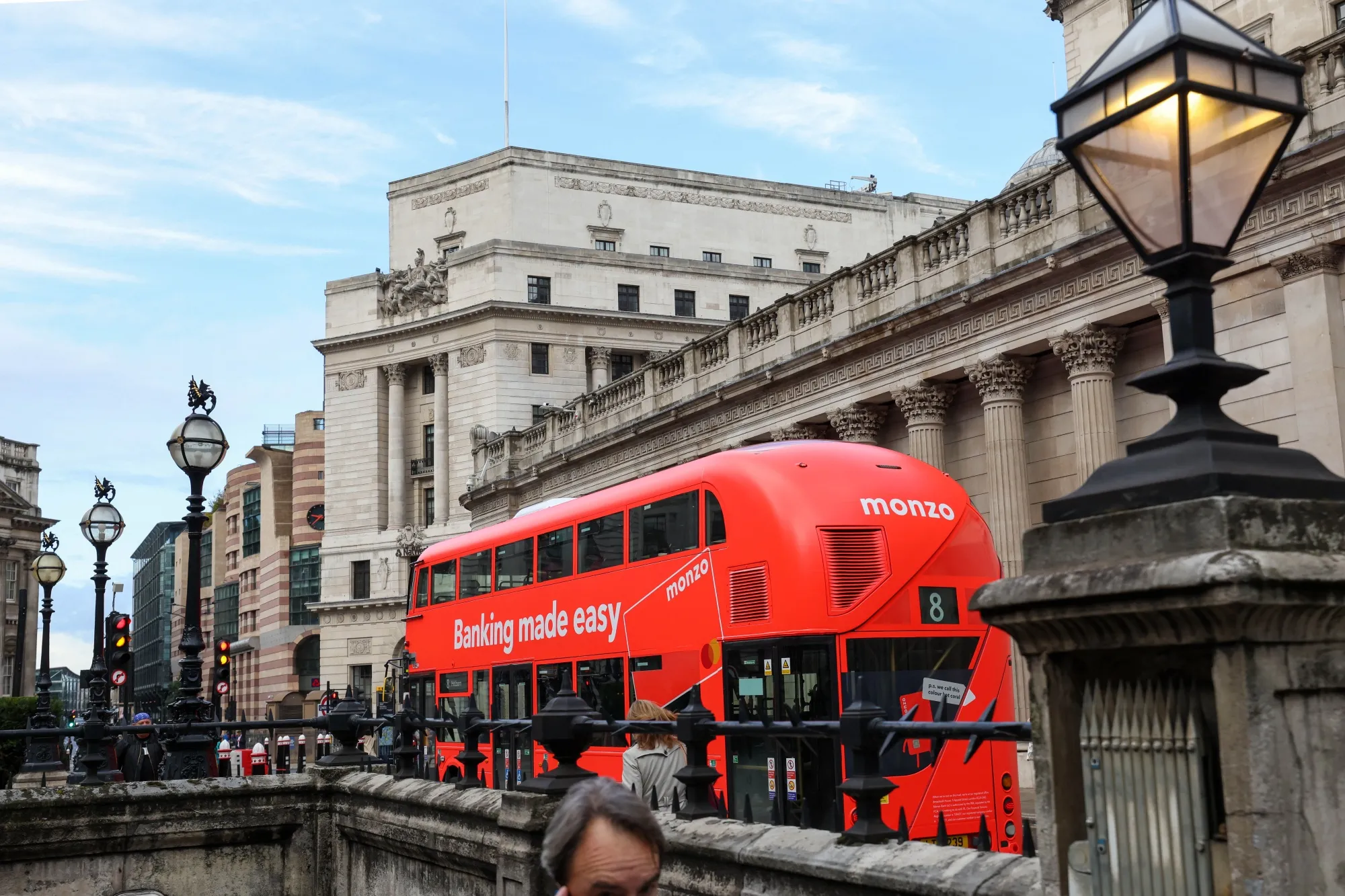 A bus with an advertisement for Monzo Bank in the City of London.