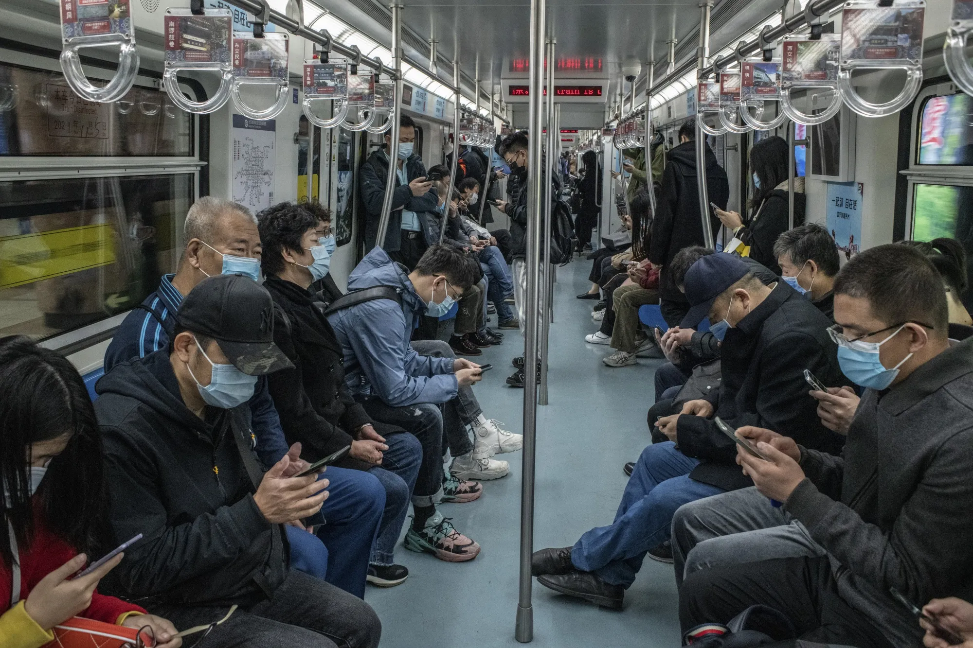 Mask-wearing passengers on the subway in Beijing, China, in November.