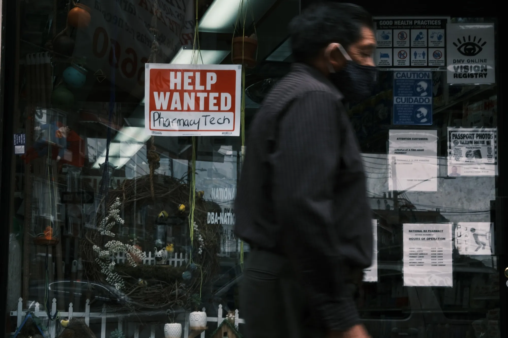 People walk by a Help Wanted sign in the Queens borough of New York City.